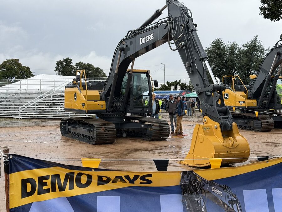 Two John Deere P-Tier excavators on the demo pads behind the DEMO DAYS banner at the Oklahoma State Fairgrounds